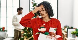 A young woman stressed about the holidays